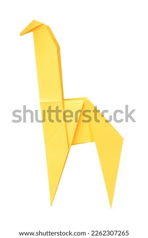 Origami art. Handmade yellow paper giraffe isolated on white