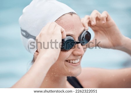 Training, sports or happy woman in swimming pool or water for practice, workout or body fitness. Wellness, smile or healthy girl athlete in goggles exercising for cardio, endurance or exercise goals