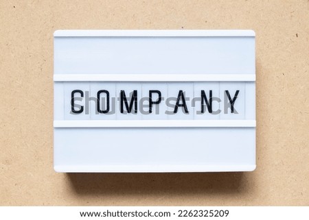 Lightbox with word company on wood background