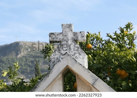 Cross of The Turk Catholic Church wit Orange Tree in Hatay, Turkey Royalty-Free Stock Photo #2262327923