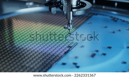 Silicon Dies are being Extracted by a Pick and Place Machine from Wafer and Attached to Substrate. Computer Chip Manufacturing at Factory. Close-up of Semiconductor Packaging Process. Royalty-Free Stock Photo #2262331367