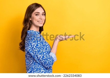 Profile side photo of adorable gorgeous lady hand demonstrate empty space offer proposition isolated on yellow color background