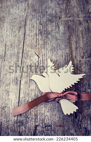 Two white birds with ribbon on wooden background. Romantic Card for Valentines day/ Birds as a symbol of love