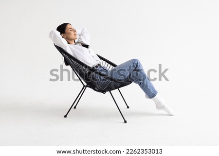 Young woman relaxing in armchair on white background Royalty-Free Stock Photo #2262353013