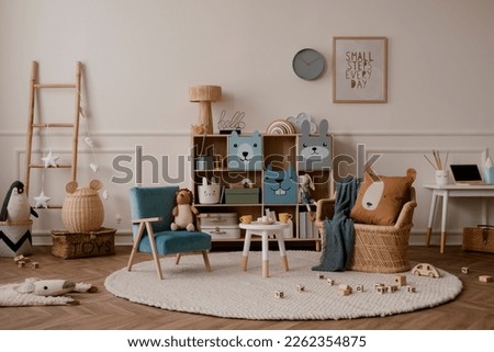Warm and cozy kids room interior with mock up poster frame, beige wall with stucco, colorful sideboard, braided armchair, plush toys, brown pillow and personal accessories. Home decor. Template. 