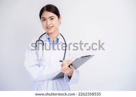 Medical concept of Asian female doctor in white coat with stethoscope and note board on white background