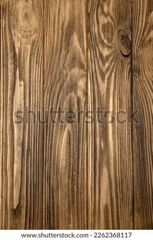 Brown textured wooden background, burnt wood. Background of yellow wooden boards for design