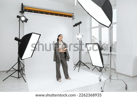 Beautiful young model posing in modern studio. Professional photo session