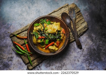 Chicken Woku or Ayam Woku is Spicy basil chicken from Manado, Indonesia and It has a rich aroma and spicy taste. Royalty-Free Stock Photo #2262370529