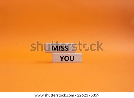 Miss you. Concept word Miss you on wooden cubes. Beautiful orange background. Business and Miss you concept. Copy space.