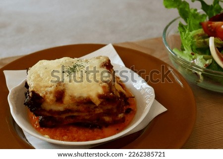 Lasagna is a traditional Italian pasta dish. This picture was taken of a set menu of lasagna and salad.