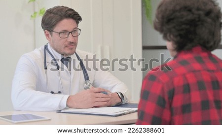 Middle Aged Doctor Talking with Patient