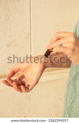 Essential oils roller bottle in the hand of a woman
