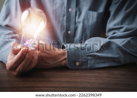 Business Man in work clothes, holding light bulb, financial concept, success, with coppy Space.
