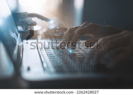 Through a holographic interface, the concept of artificial intelligence connects to business and industrial control with robot hands and human touch to learn from intelligence. Royalty-Free Stock Photo #2262428027