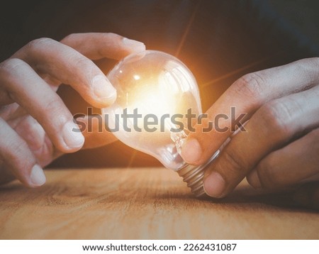 hand holding light bulb. idea concept with innovation and inspiration.new ideas Great inspiration and innovation new beginning.
