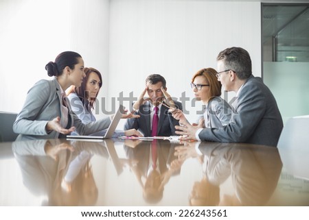 Businesspeople arguing in meeting Royalty-Free Stock Photo #226243561