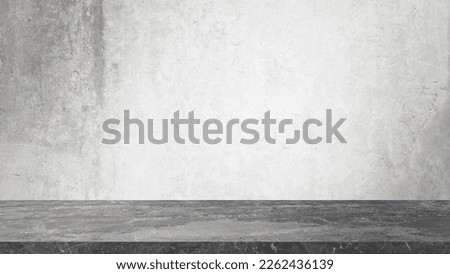 grey marble table in front of rusty grey concrete wall background with lighting from above. panoramic banner mockup for advertising and product displayed. indutrial interior concept for loft design.