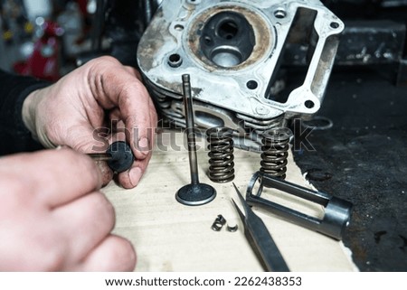 Motorcycle engine repair and reconditioning                        Royalty-Free Stock Photo #2262438353