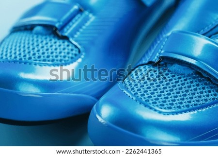 Blue bicycle shoes on a blue background