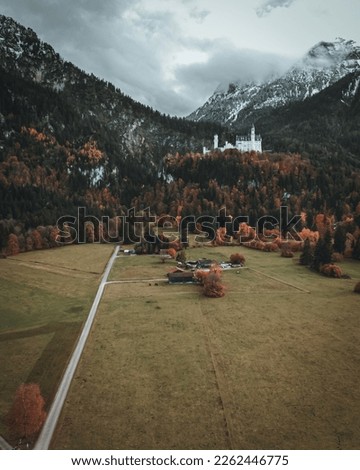 The iconic castle Neuschwanstein during autumn, shot with a drone.