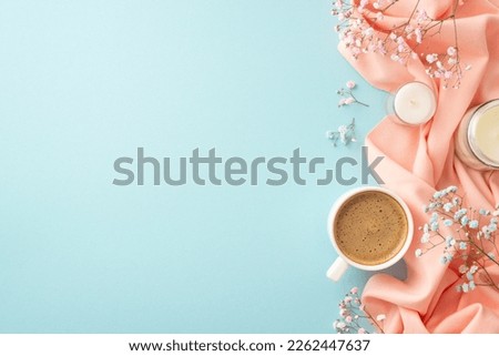 Hello spring concept. Top view photo of cup of fresh coffee candles in glasses gypsophila flowers and pink soft plaid on isolated pastel blue background with empty space