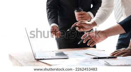 Meeting of business people pointing at graphs and charts to analyze market data, balance sheet, account, net profit, to formulate new sales strategy to increase productivity using laptop computer. Royalty-Free Stock Photo #2262453483