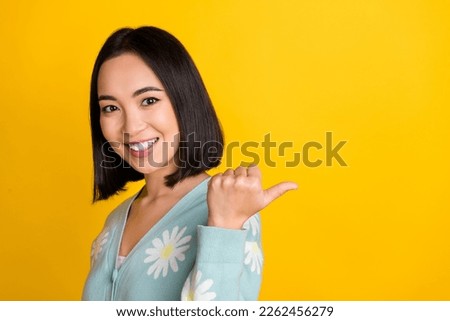 Photo of positive lovely lady wear stylish clothes thumb direct empty space opening beauty salon isolated on yellow color background