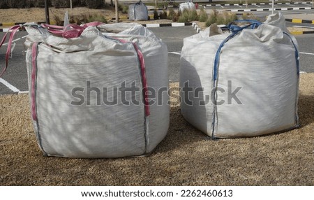 White sacks of one cubic meter. Full white sacks in the street. Royalty-Free Stock Photo #2262460613