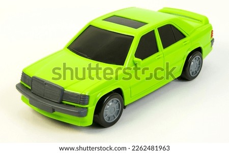 A light green car with tinted windows on a white background. Toy vehicles, outdoor games for children.