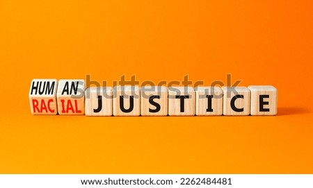 Racial or human justice symbol. Concept words Racial justice Human justice on wooden cubes. Beautiful orange table orange background. Ecological racial or human justice concept. Copy space.