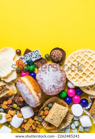 An assortment of unhealthy foods that are bad for the figure, skin, heart and teeth. Fast carbohydrate food. Space for text