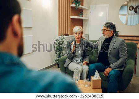 Portrait of a mature or senior spouses meeting therapist or counseling psychologist in an office. Discussing couple issues and finding solution to relationship problem. Copy space.