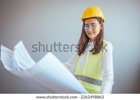 Beautiful young asian woman engineer and safety helmet on white background, construction concept, Engineer, Industry. Female entrepreneur determined to win.