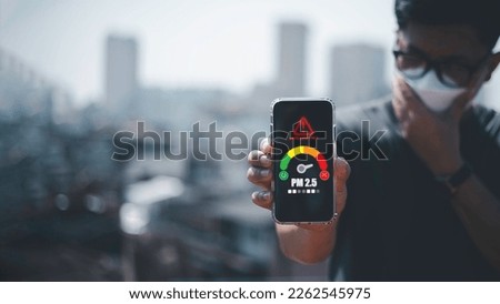 man scanning the weather on his mobile phone Ecological concept. Allergies. Headache.N95 PM 2.5 from air pollution and dust beyond safety standards. health care, environment, Royalty-Free Stock Photo #2262545975