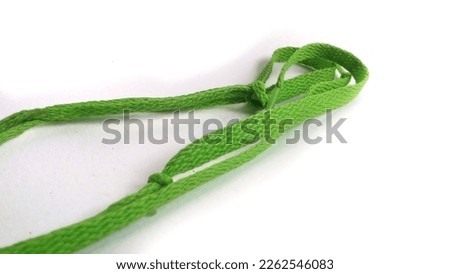 Green shoelace isolated on white background, top view