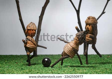 mini figure act like they playing football in the yard