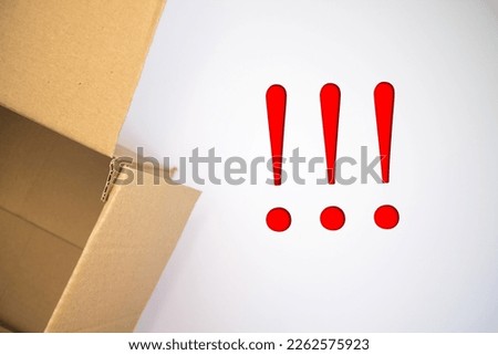 Exclamation mark word with cardboard box. Brown folded card box.