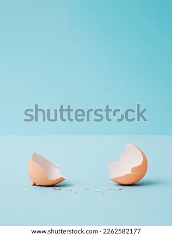 Minimal Abstract easter composition with egg broken eggshells and copy space . Modern collage on pastel blue background. Creative art minimal aesthetics Royalty-Free Stock Photo #2262582177