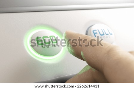 Finger pressing eco mode button. Energy saving and reducing electricity concumption concept. Royalty-Free Stock Photo #2262614411