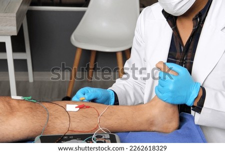 Electromyography in the lower limbs, graphic recording technique of the electrical activity produced by the tibial muscle performed by a specialist neurologist
 Royalty-Free Stock Photo #2262618329