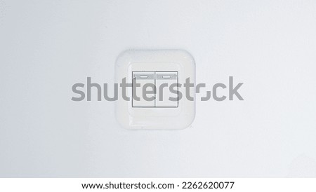 Modern double light switch on white wall