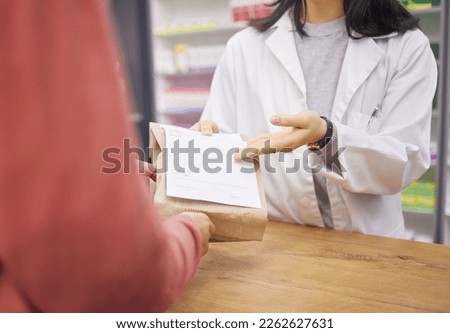 Pharmacy, paper bag and medical hands for customer services, healthcare support and retail product help desk. Woman advice for pharmaceutical drugs, clinic medicine and receipt to client or patient Royalty-Free Stock Photo #2262627631