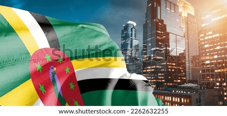 Dominica national flag cloth fabric waving on beautiful building background.