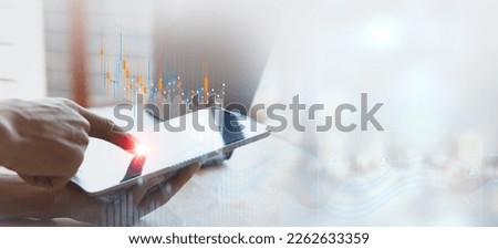 Businessman using tablet analyzing business data and financial report, economic growth graph chart. Business planning and strategy. Analysing trading of exchange. Financial and banking.