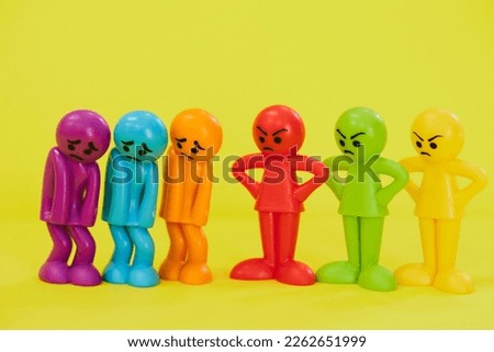 Angry people and angry colorful dolls