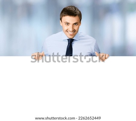 Portrait image of business man professional bank manager in confident cloth. Businessman stand behind hang over empty white banner signboard with copy space. Blurred office background