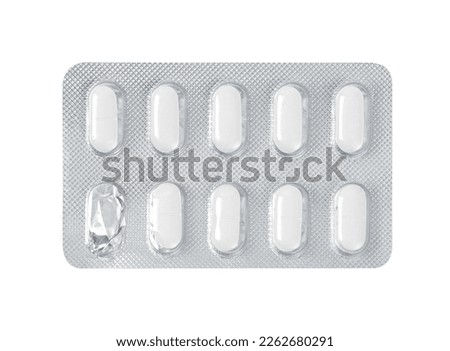 Pharmaceutical drugs in started silver blister packing with one used pill, panel packs isolated on white background. Clipping path, close up. Royalty-Free Stock Photo #2262680291