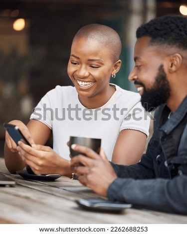 Coffee shop, social media and dating with a black couple laughing together at a table in a restaurant. Humor, love or date with a man and woman looking at a meme on a phone while bonding in a cafe