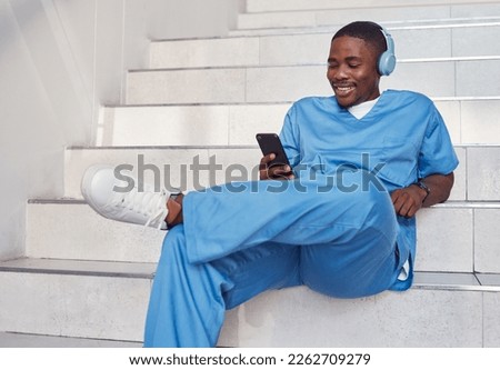 Doctor, phone and stairs for relaxing, communication or video call outside hospital for health advice. Happy black man nurse smiling in healthcare with smartphone and headset for telemedicine